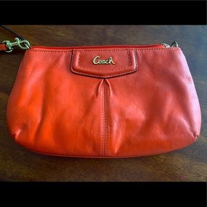 Coach wristlet, vibrant orange.